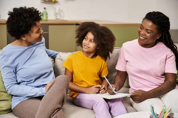 Family members engage in a joyful activity, sharing laughter and creativity together. — Stock Photo