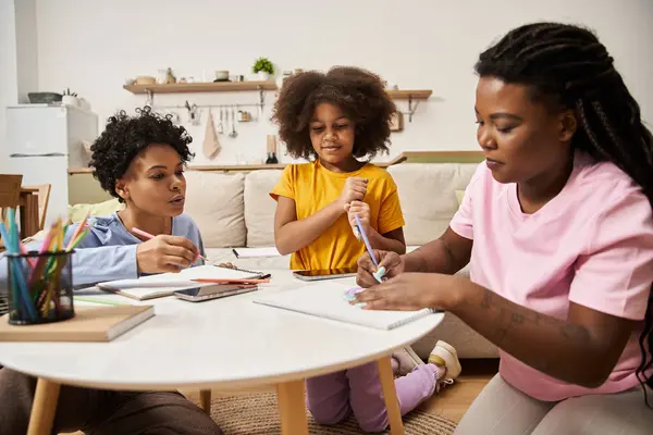 A loving family enjoys art activities at home, sharing smiles and creativity in a cozy environment. — Stock Photo