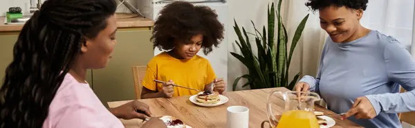 Enjoying a joyful breakfast together, a loving family shares laughter and delicious pancakes. — Stock Photo