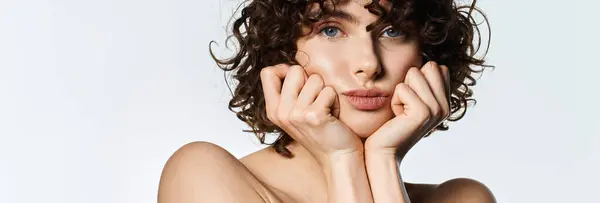 Young woman with curly hair showcases beauty through graceful poses and expressions. — Stock Photo