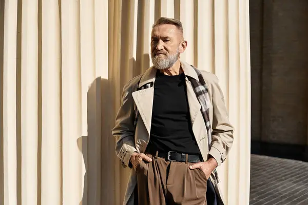 A handsome senior man exudes confidence as he strolls through the city, dressed in trendy attire. — Stock Photo