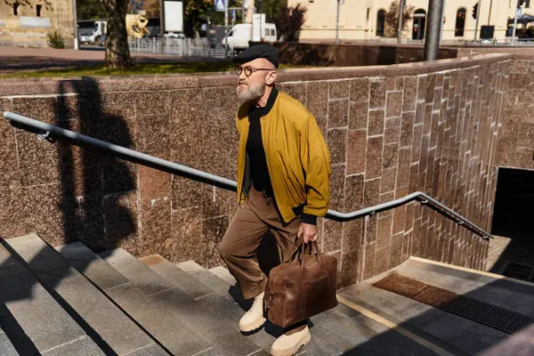 In a bustling cityscape, a stylish senior man ascends the stairs, combining fashion and elegance. — Stock Photo