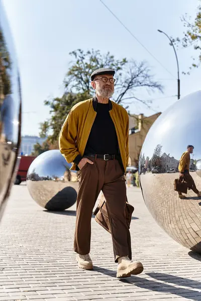 Dapper senior man exhibits his chic fashion sense while walking confidently through city landscape. — Stock Photo