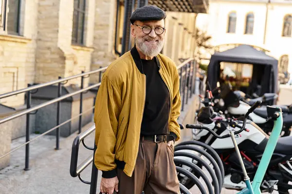 A senior man strolls casually through a vibrant city, exuding confidence in his stylish outfit. — Stock Photo