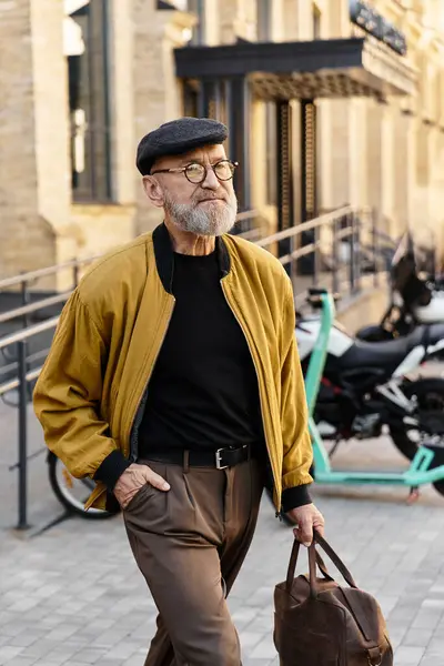 A fashionable senior man walks confidently through a trendy cityscape. — Stock Photo