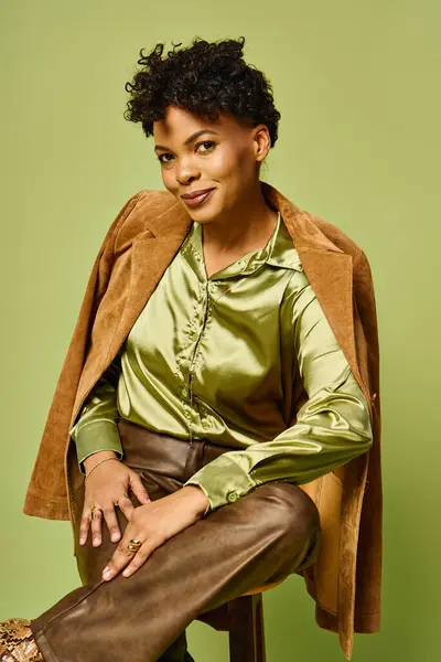 A fashionable woman showcases her trendy outfit with confidence in a chic, modern setting. — Stock Photo
