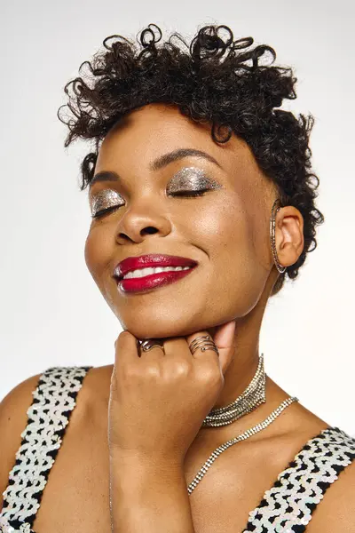 A stylish African American woman poses gracefully, showcasing her trendy look and radiant smile. — Stock Photo