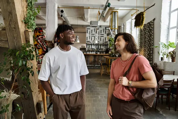 Two handsome men enjoying a lovely date at a warm, trendy cafe. — Stock Photo