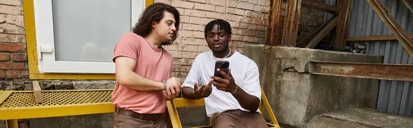 A loving gay couple enjoys their time together, sharing smiles and laughter over coffee. — Stock Photo