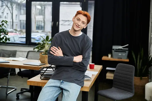 Red haired man in office showcases dedication while posing casually by his workspace and plants. — Stock Photo