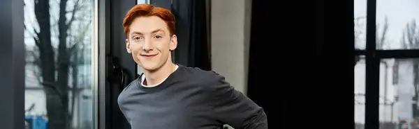 Bright eyed young man with red hair shows commitment while working in a stylish office setting — Stock Photo