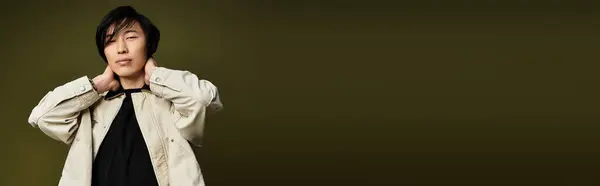 A young Asian man showcases his fashion sense while posing elegantly in a studio setting, banner — Stock Photo