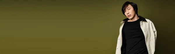 Young man showcases a trendy outfit and striking presence in a chic studio setting, banner — Stock Photo