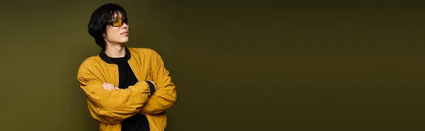 A confident young man exudes style and charm while posing in a contemporary studio setting, banner — Stock Photo