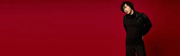 Handsome asian man poses stylishly in a red studio, banner — Stock Photo
