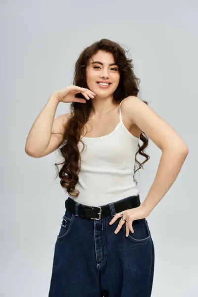 Confident young woman showcases her stylish ensemble with playful charm and radiant smile. — Stock Photo