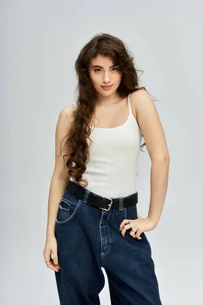 Young woman with beautiful hair showcases her fashion sense in a vibrant studio setting. — Stock Photo