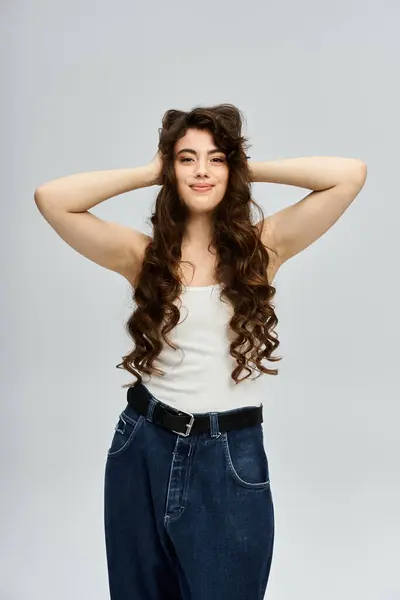 A young pretty woman stands confidently, showcasing her stylish attire and playful demeanor — Stock Photo