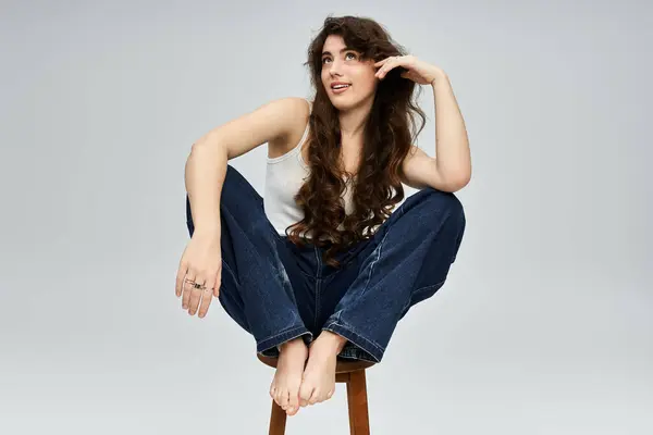 A chic young woman showcases her charm and personality through fashion in a modern studio. — Stock Photo