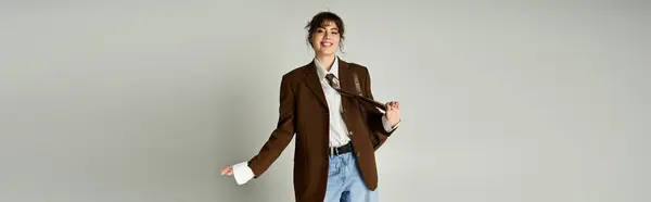 A young woman smiles in stylish attire, showing off her playful personality. — Stock Photo