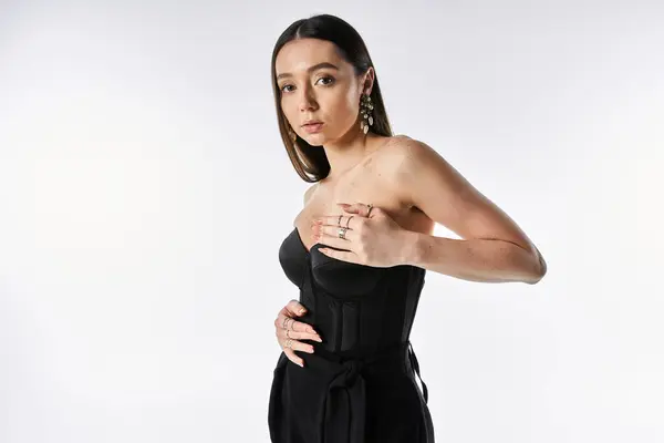 Charming woman in stylish attire poses confidently, showcasing modern fashion choices. — Stock Photo