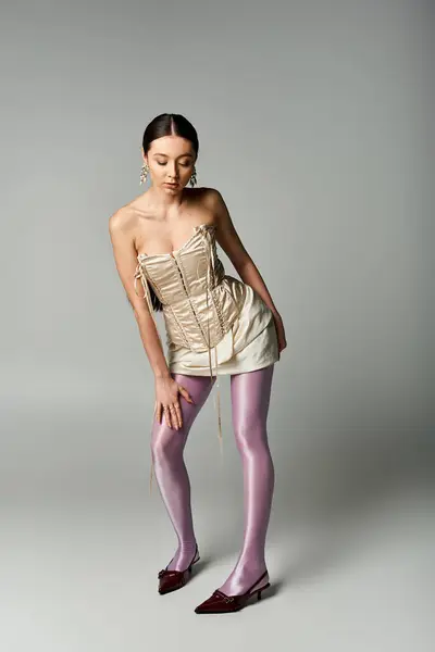 Stylish young woman poses elegantly in trendy attire with a unique mix of colors and textures. — Stock Photo
