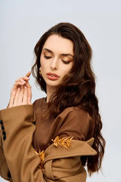 Une jeune femme dans un manteau élégant se tient gracieusement, embrassant la nature. — Photo de stock