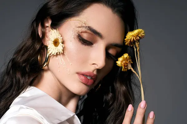 A young woman with brown hair admires spring flowers while showcasing her natural beauty. — Stock Photo