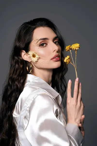A young woman surrounded by beautiful flowers, showcasing her graceful beauty in spring. — Stock Photo