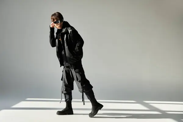 Stylish Asian man poses confidently in trendy attire, flaunting a unique fashion flair. — Stock Photo