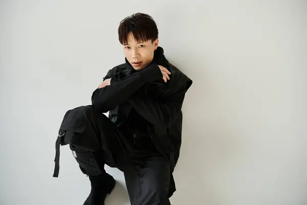 A handsome young Asian man showcases his unique style and charisma in a contemporary environment. — Stock Photo