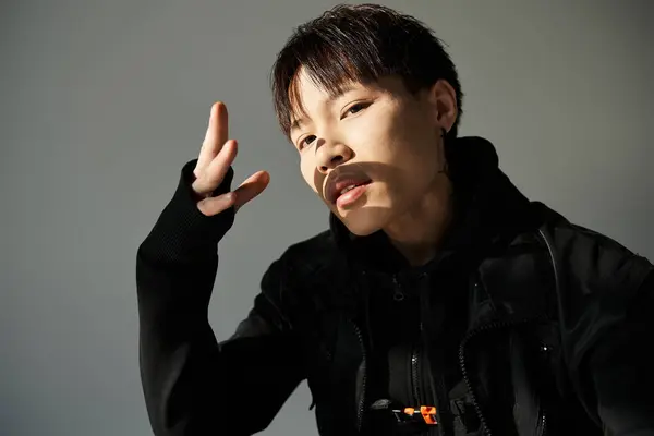 Stylish young Asian man exudes confidence and charisma indoors. — Stock Photo