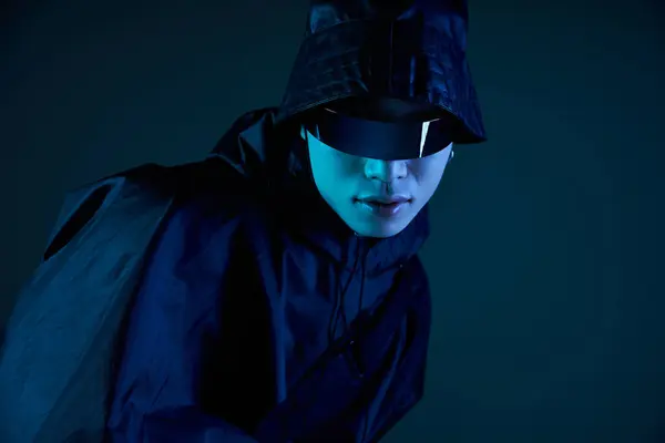 Handsome Asian man shows off his style in shades and a sleek outfit under dim light. — Stock Photo