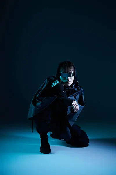 A stylish Asian man crouches confidently, showcasing modern fashion trends. — Stock Photo