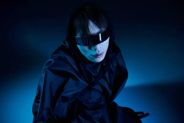 A stylish Asian man in black sunglasses stands out against a striking blue backdrop. — Stock Photo