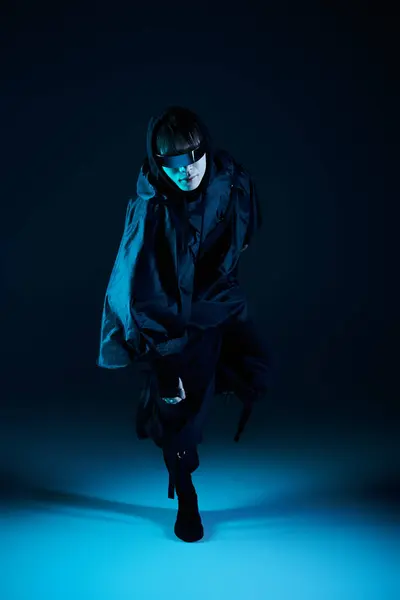 A stylish young man exudes confidence against a striking blue backdrop. — Stock Photo
