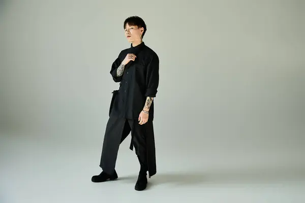 A handsome asian man poses confidently in trendy attire, showcasing modern fashion details. — Stock Photo