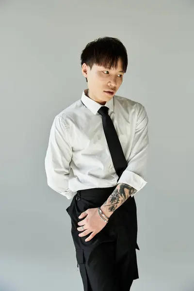 Handsome asian man poses confidently in a white shirt and tie, showcasing his unique style. — Stock Photo