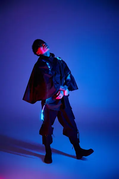 A stylish young man stands confidently in a striking outfit, showcasing his unique flair. — Stock Photo