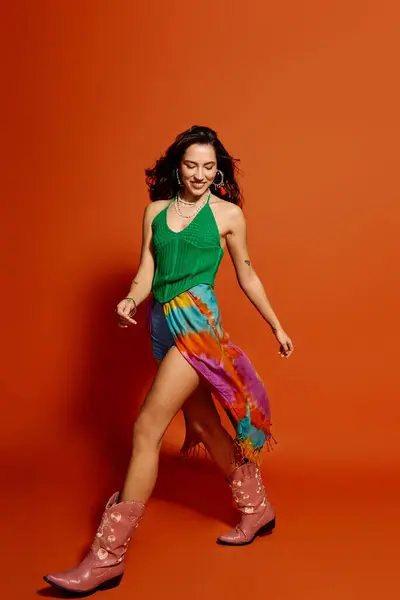 A young beautiful woman joyfully walks in a stylish outfit that radiates warm summer vibes. — Stock Photo