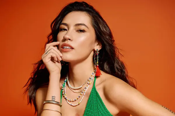 Young woman models vibrant summer wear and stylish accessories against a bold backdrop. — Stock Photo
