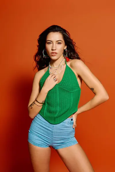 A young woman poses confidently in summer attire, showcasing her stylish look and energy. — Stock Photo
