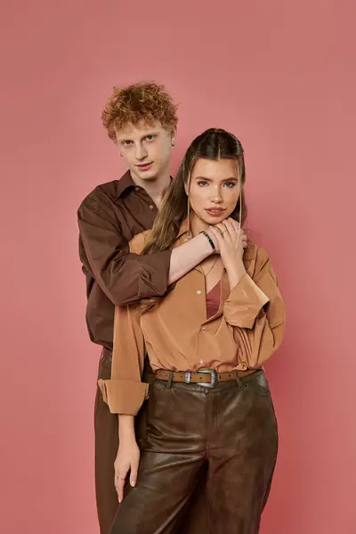 Стильная пара разделяет нежный момент в модных нарядах, излучающих любовь и связь. — стоковое фото