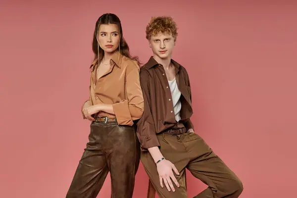 Stylish pair stands confidently, showcasing their modern attire and deep bond in a playful setting. — Stock Photo