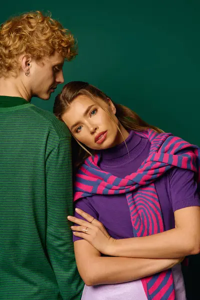 A stylish couple enjoys each others company in a vibrant setting showcasing modern fashion. — Stock Photo