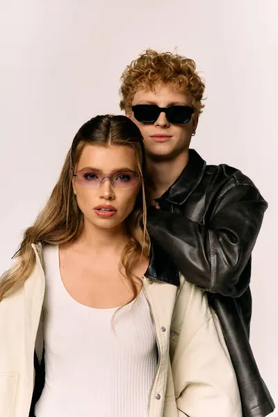 A stylish couple stands close, radiating love and charm in vibrant outfits. — Stock Photo
