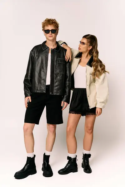 Couple shows off trendy outfits in a stylish, romantic pose, exuding joy and confidence. — Stock Photo