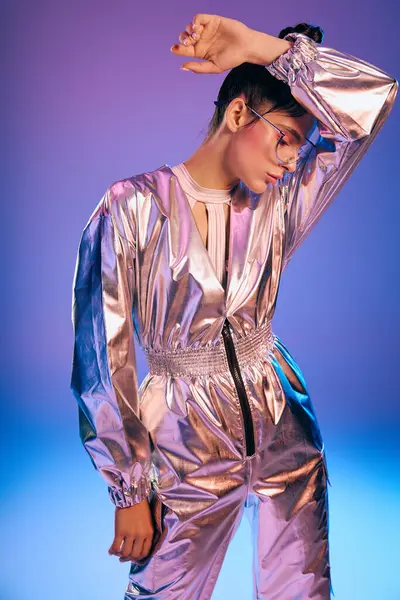 Fashion forward woman poses in metallic attire, radiating vibrancy in a futuristic atmosphere. — Stock Photo