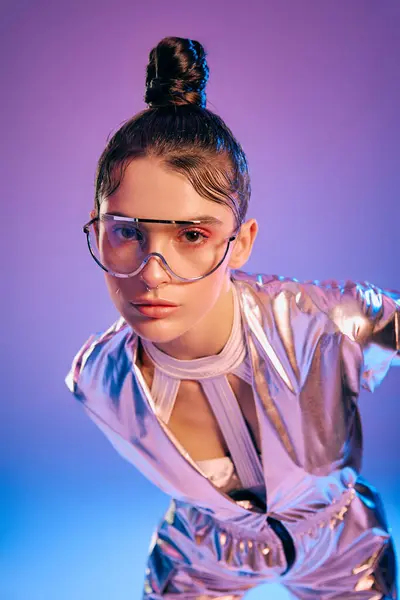 A young woman poses confidently in sleek, holographic futuristic clothing. — Stock Photo