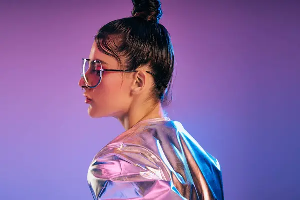 A fashionable woman showcases her modern style, featuring holographic colors and futuristic attire. — Stock Photo